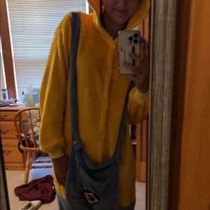 Minions onsie with minion face on the hood, and suspenders on the body